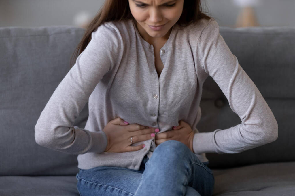 Sick,Young,Woman,In,Pain,Holding,Belly,Stomach,Feeling,Hurt