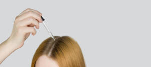 A,Glass,Pipette,With,A,Hair,Growth,Agent,Is,Applied